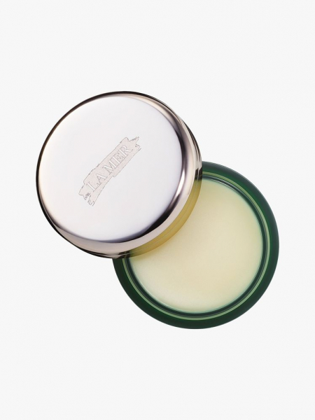 La Mer The Lip Balm top view of a green jar of lip balm with silver cap ajar on light gray background